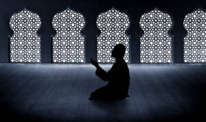 Silhouette of muslim man praying